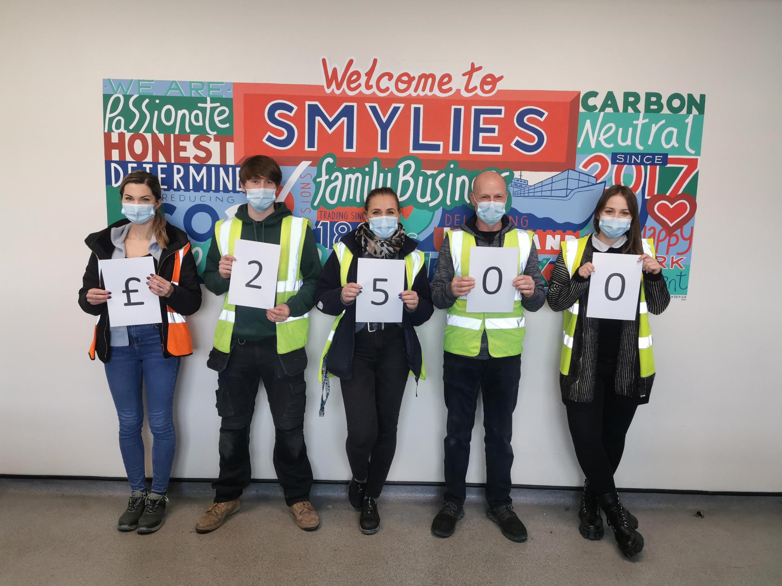 Smylies Staff celebrating raising £2,500 for charity.