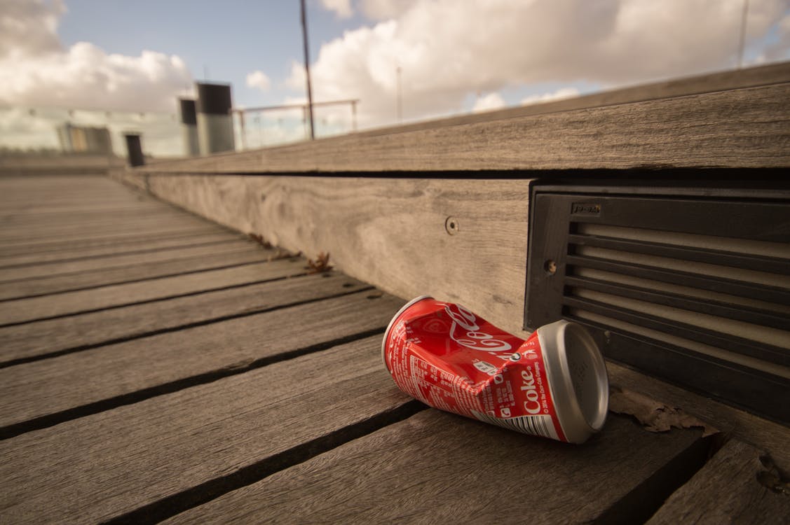 Coca Cola can squashed on floor